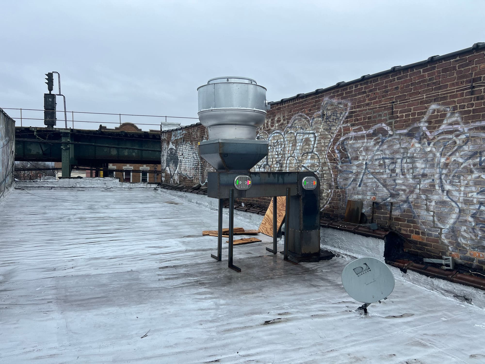 Rooftop commercial kitchen exhaust fan installed on a New York City building